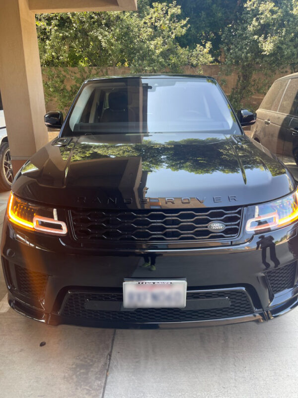 Black Range Rover with blurred-out plate number